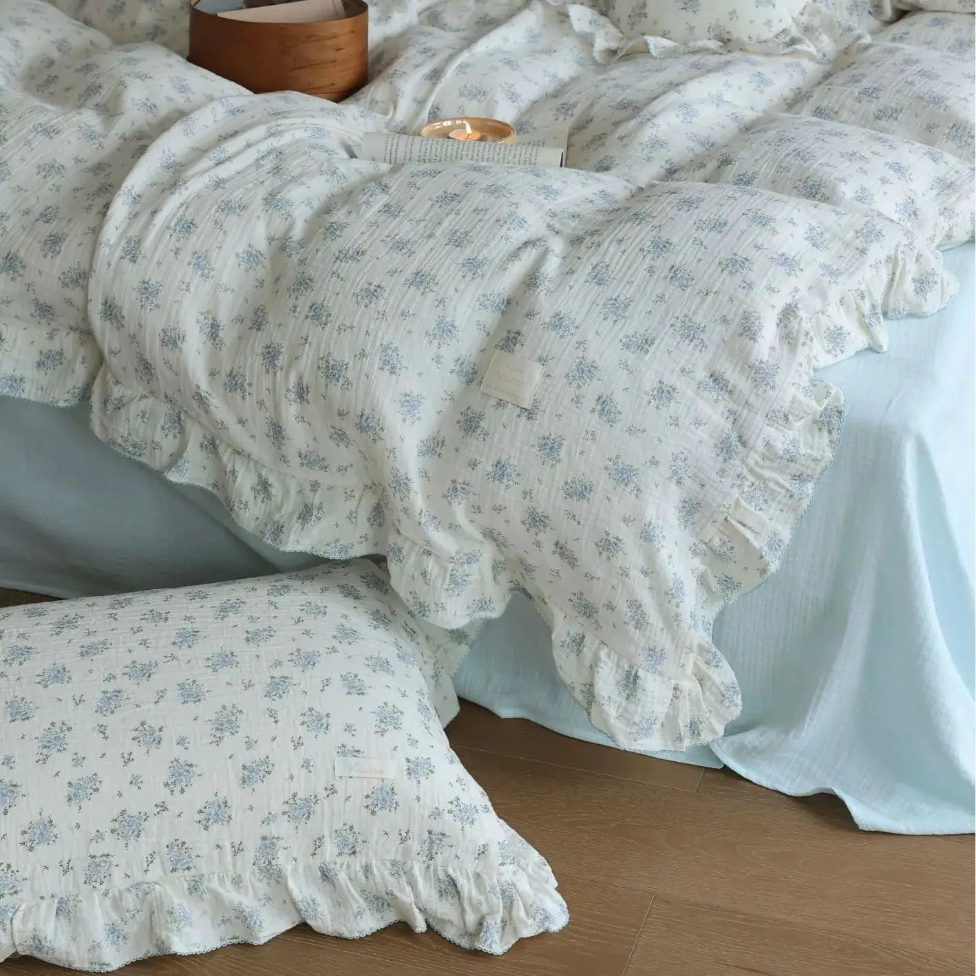 Duvet cover set by Simples Market; 3-piece white gauze cotton with blue floral print and ruffle-edge trim