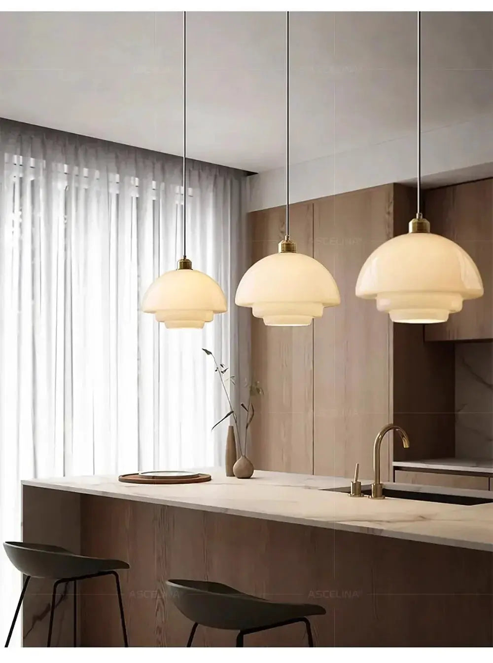 Nordic glass pendant lamps, three warm-white layered dome shades on cords over a marble kitchen island.