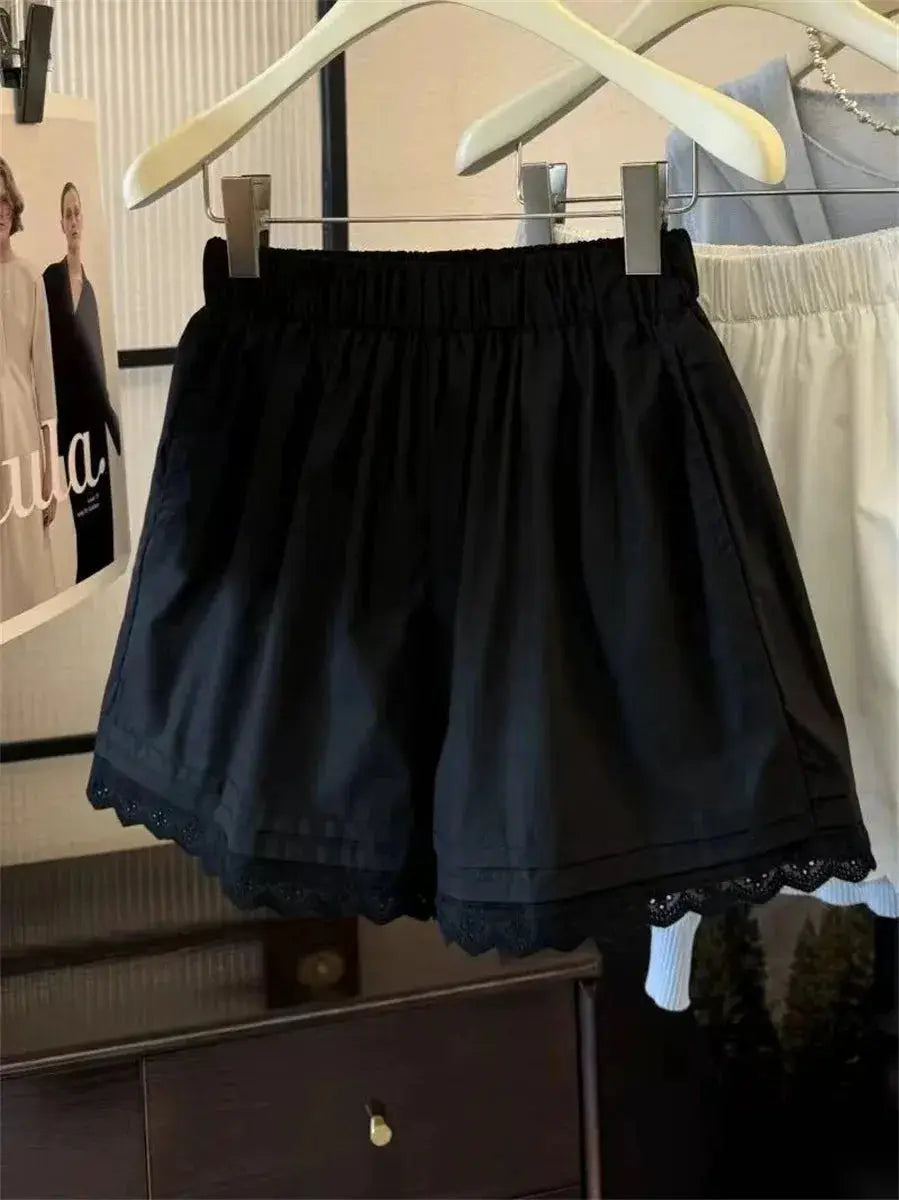 Two pairs of black high-waisted lace-trim patchwork shorts for women, wide-leg casual vacation wear.