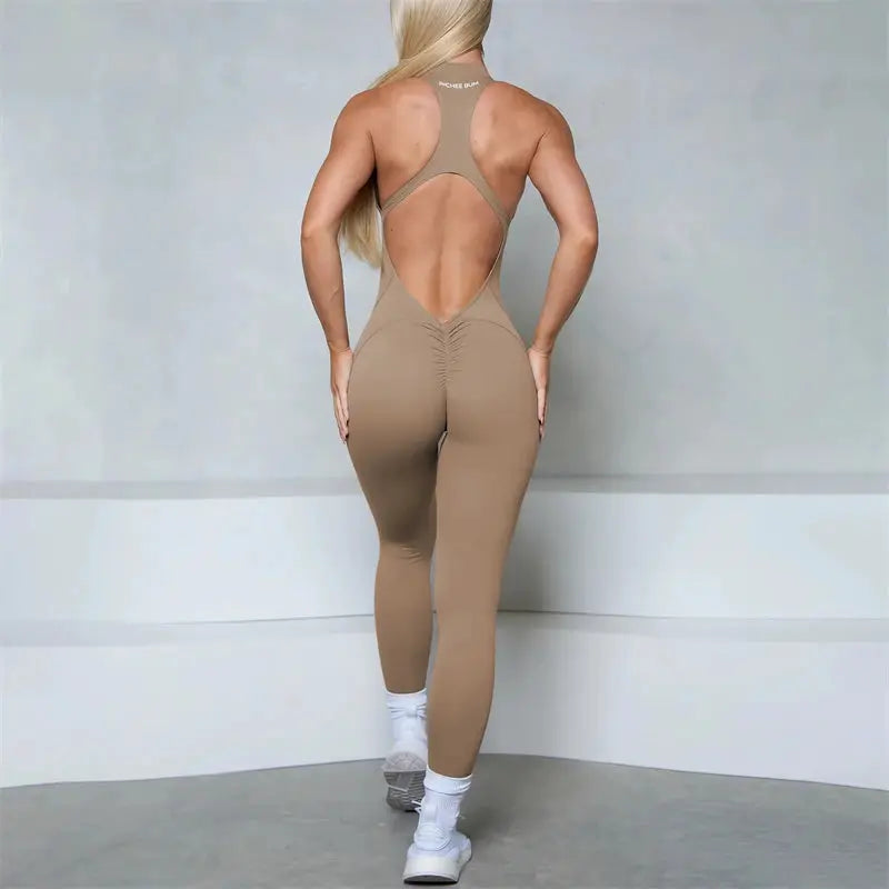 Women beige sleeveless jumpsuit with zip, open-back racerback and scrunch butt seams for gym wear.