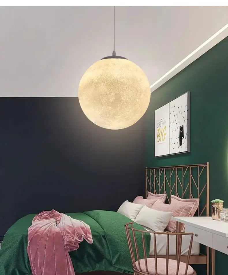 Simples Market Nordic Moon LED pendant light; round warm-glow globe hangs over a green bedroom with a copper headboard.