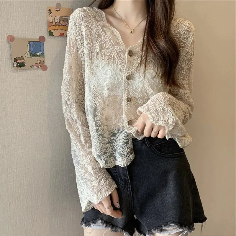 Vintage lace blouse for women, ivory sheer long sleeves with button front, paired with black denim shorts.