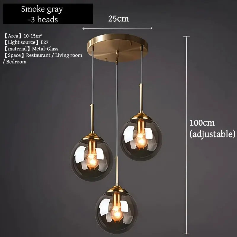 Three-globe smoke-gray glass pendant chandelier with brass metal finish by Simples Market, adjustable 100 cm.