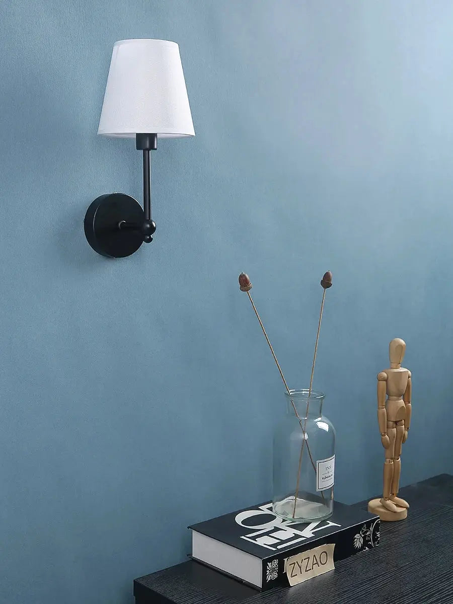 American Retro wall lamp by Simples Market; black metal sconce with white fabric shade.