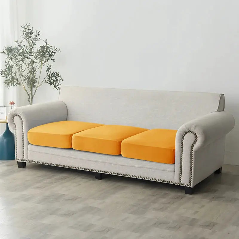 Plush sofa slipcover, anti-slip elastic, light gray with orange cushions on a living room sofa