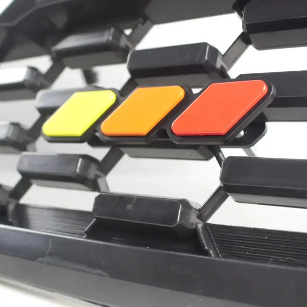Grille badge emblem set in yellow, orange, and red for Toyota vehicles by Simples Market
