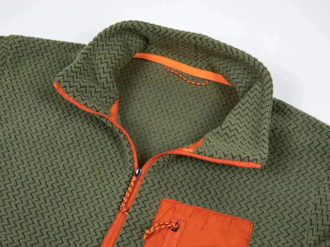 Olive green fleece jacket with orange zipper and pocket, featuring a textured wavy knit
