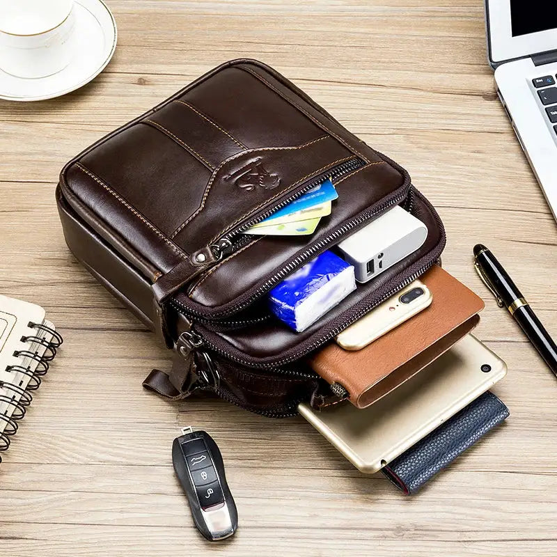 Men's brown leather crossbody bag by Simples Market with multiple zip compartments.