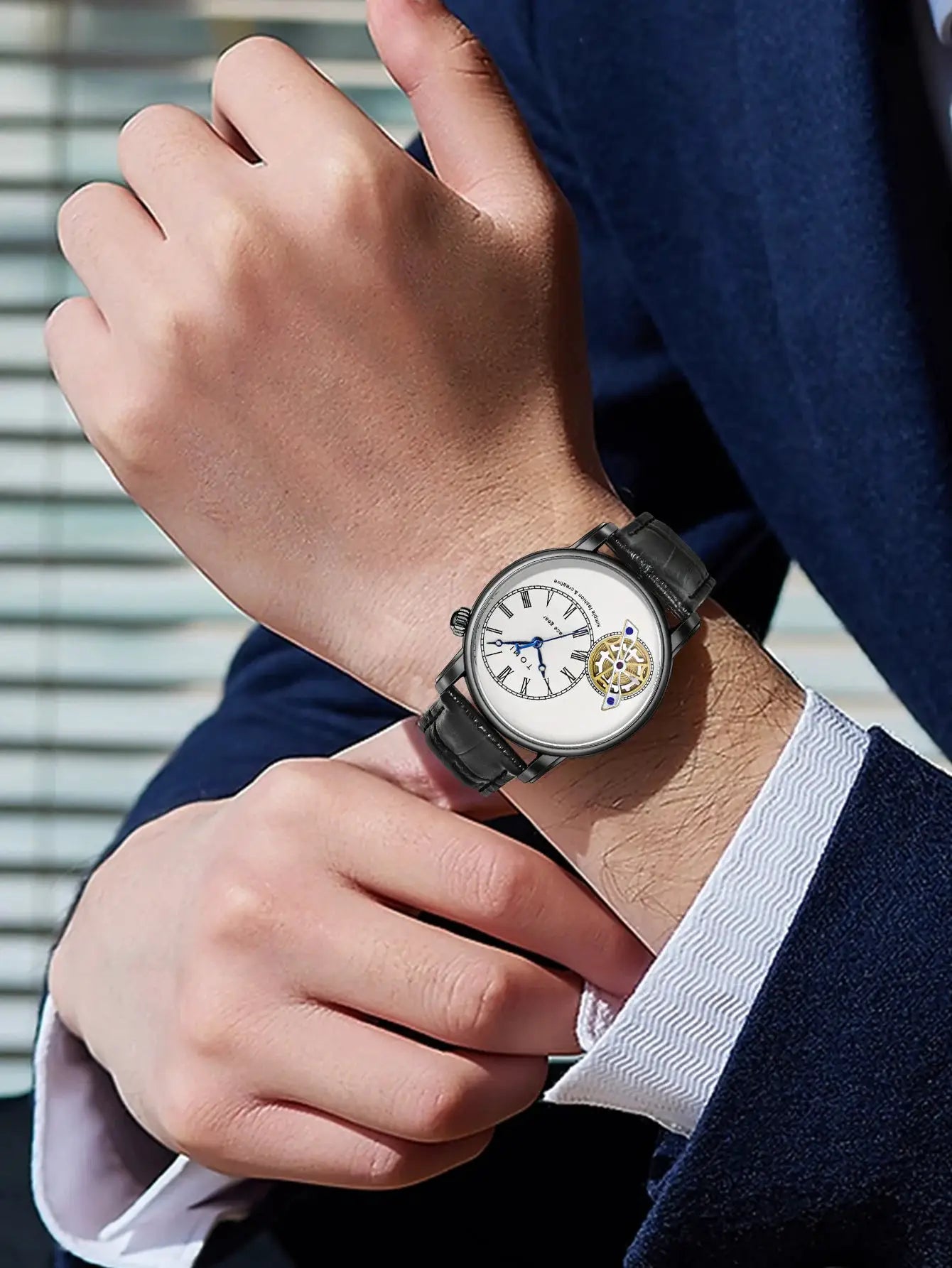 TOMI men's quartz watch with black leather strap, silver case, white dial with Roman numerals and visible gear