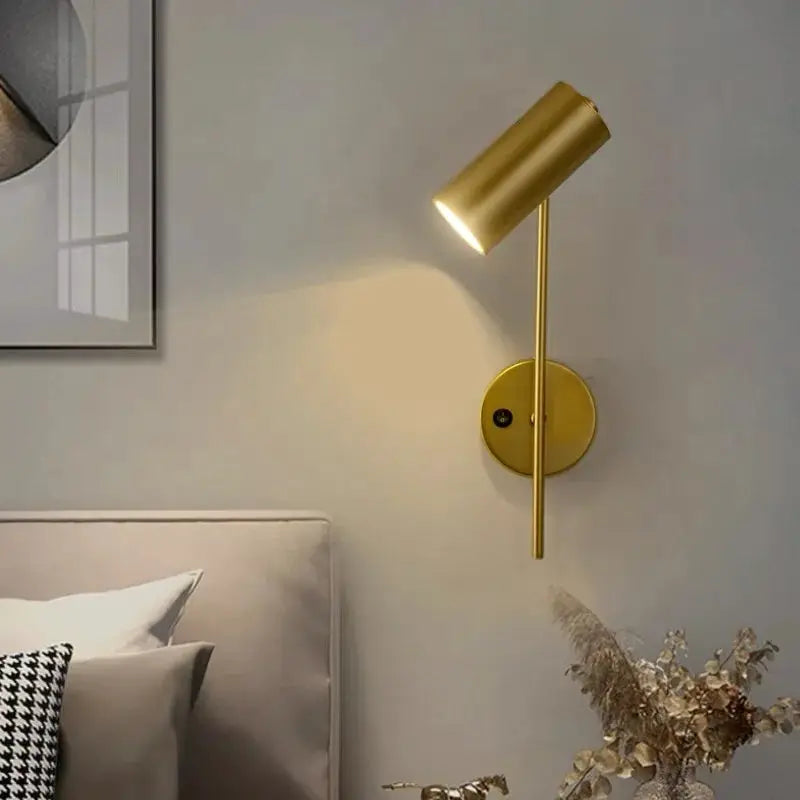Rotatable hotel bedroom wall lamp in brass finish with a plastic shade and E27 LED reading light.