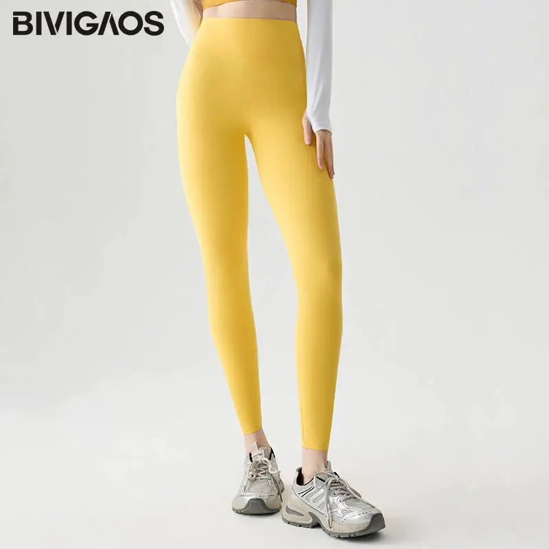 Seamless sharkskin leggings by BIVIGAOS for women in yellow, high-waisted stretchy athletic tights.