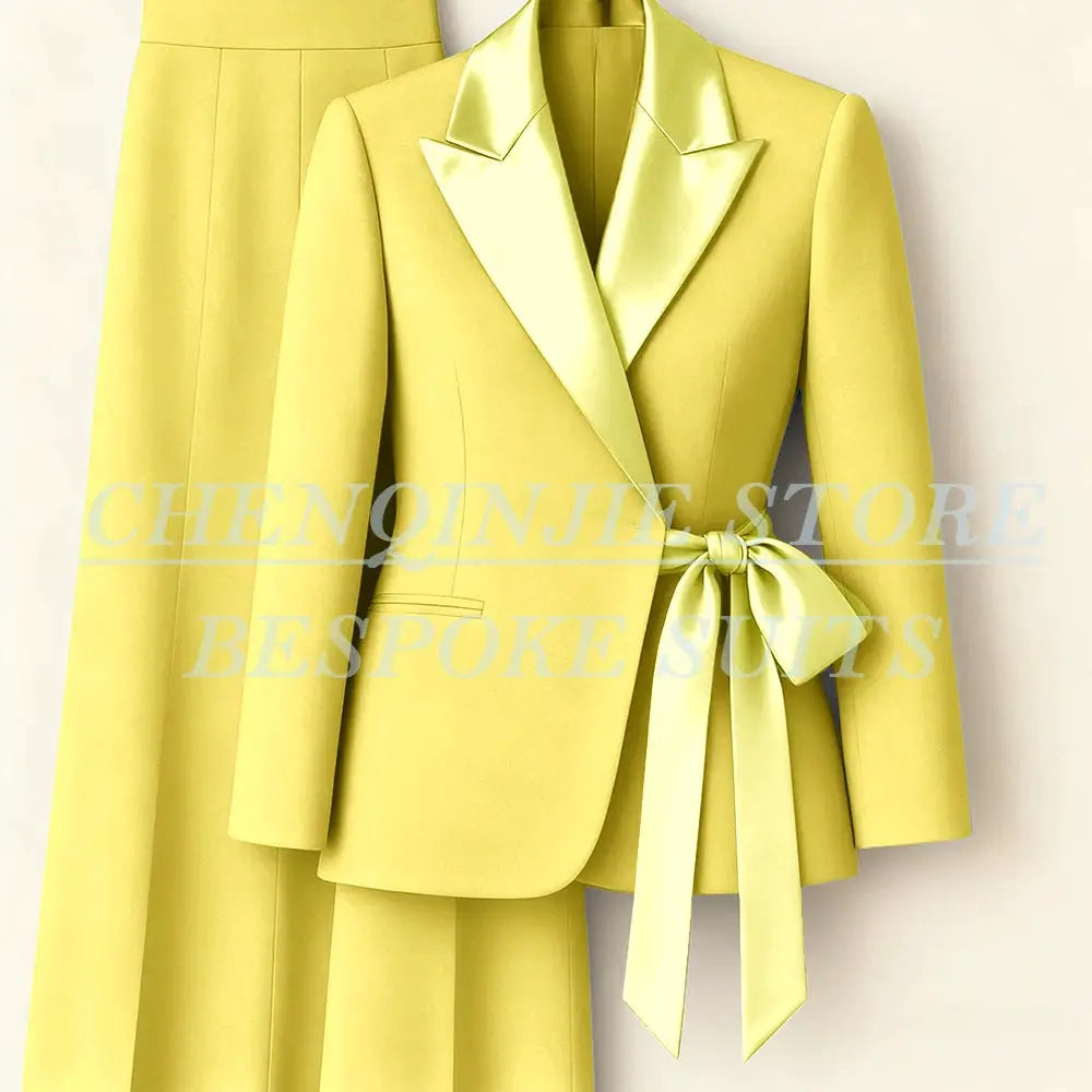 Women's yellow 2-piece blazer suit with peak lapels and waist belt, matching pants.