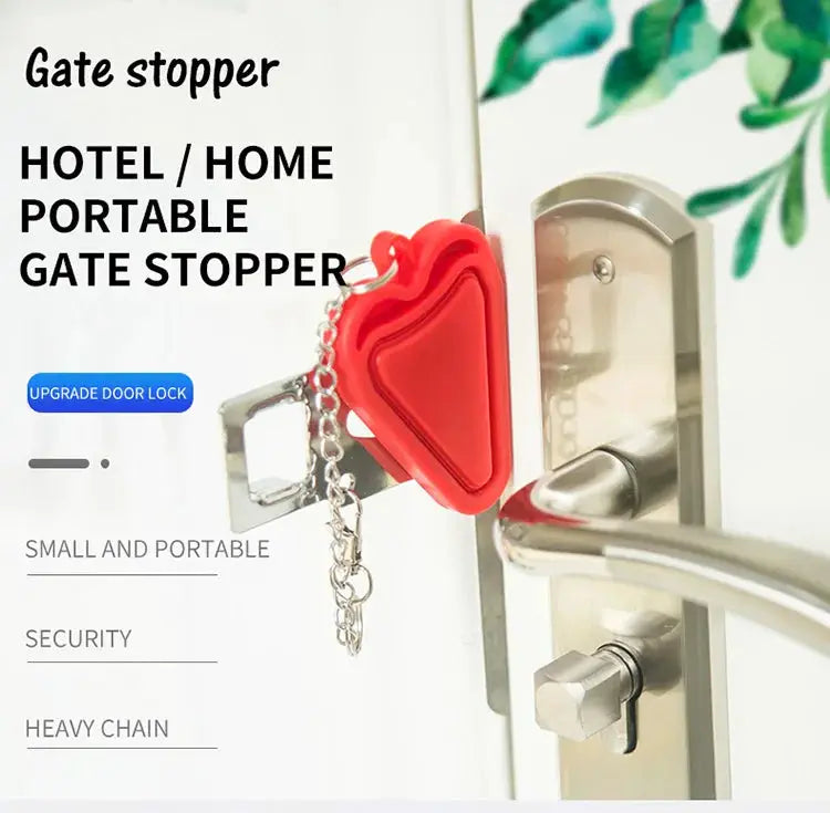 Portable door lock latch, red with chain, attached to a metal door handle for travel security.