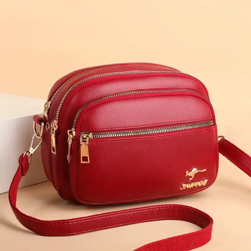 Simples Market red leather shoulder messenger bag with multiple pockets, gold-tone zippers, wear-resistant handbag