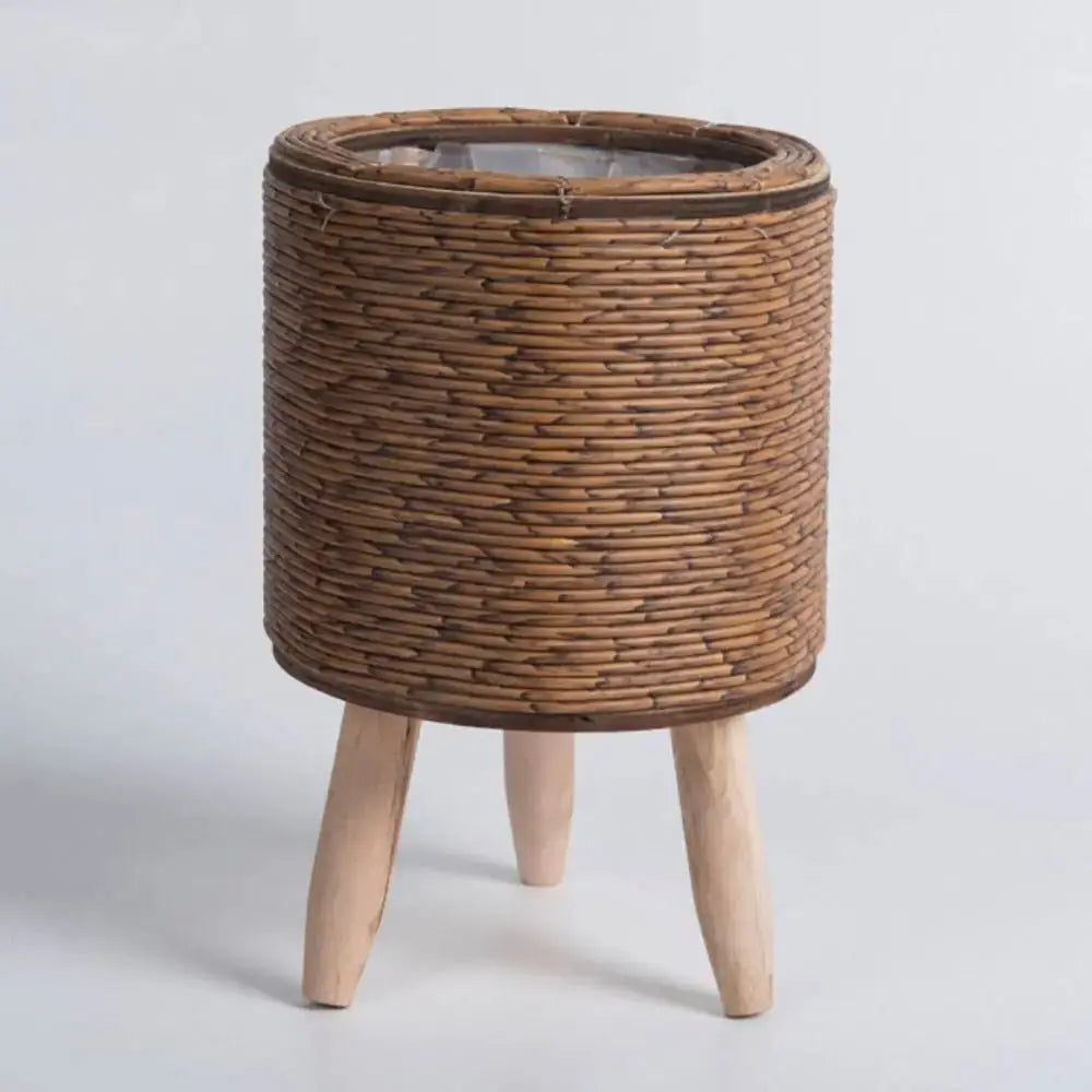 Rattan woven flower pot with removable legs plant stand in natural brown.