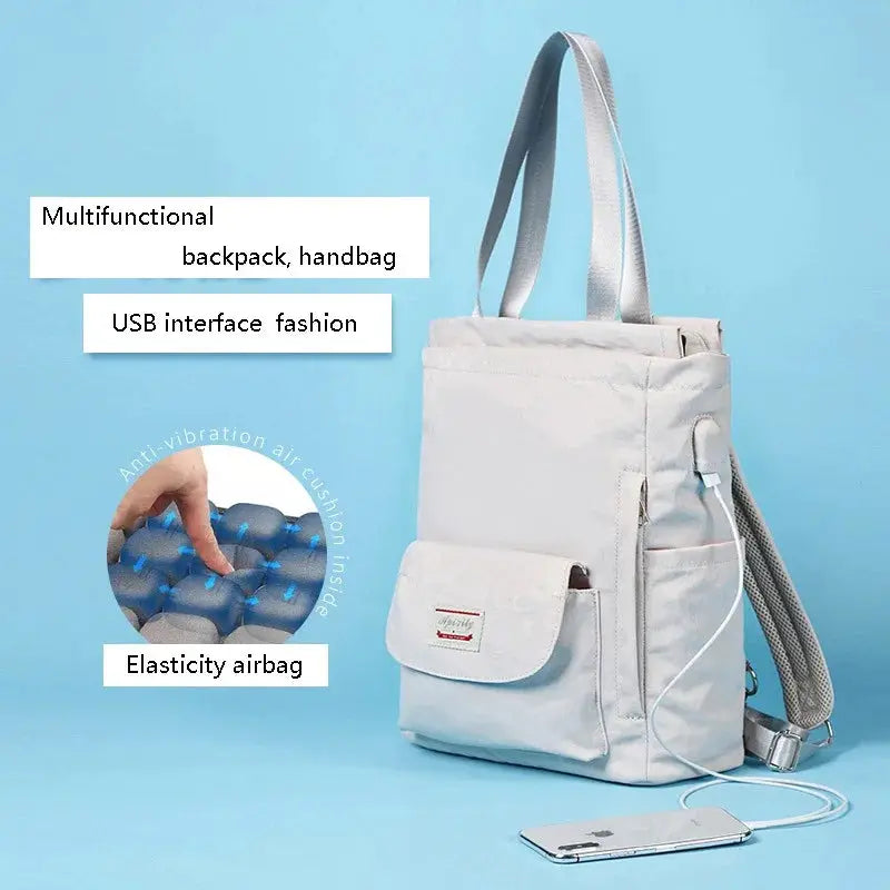Simples Market women's waterproof laptop backpack in light blue canvas with USB charging port.
