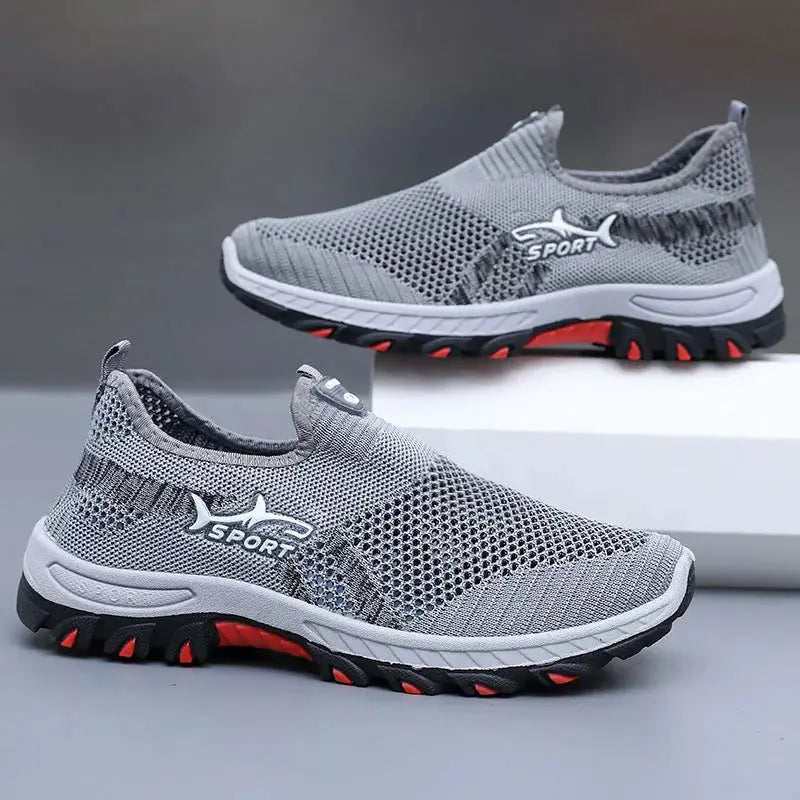 Pair of men's sport mesh sneakers, grey breathable knit, rubber outsole with red accents