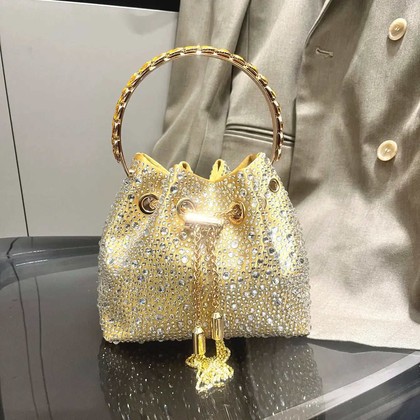 Simples Market rhinestone evening clutch bag with gold-tone circular handle and crystal-studded beige body