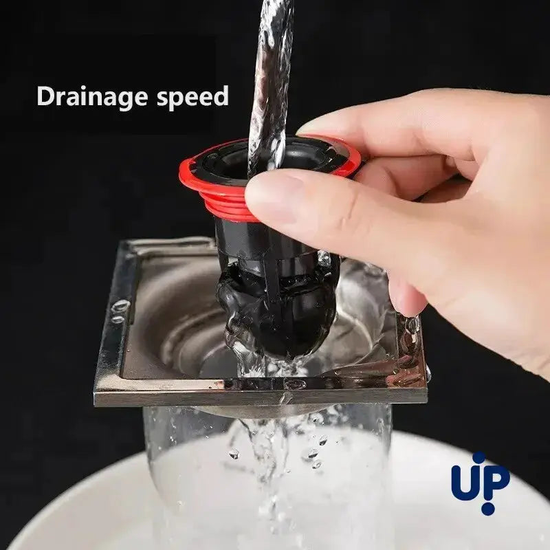 Floor drain anti-odor core with black plastic body and red ring inserted into a metal drain; 1 pc UP.
