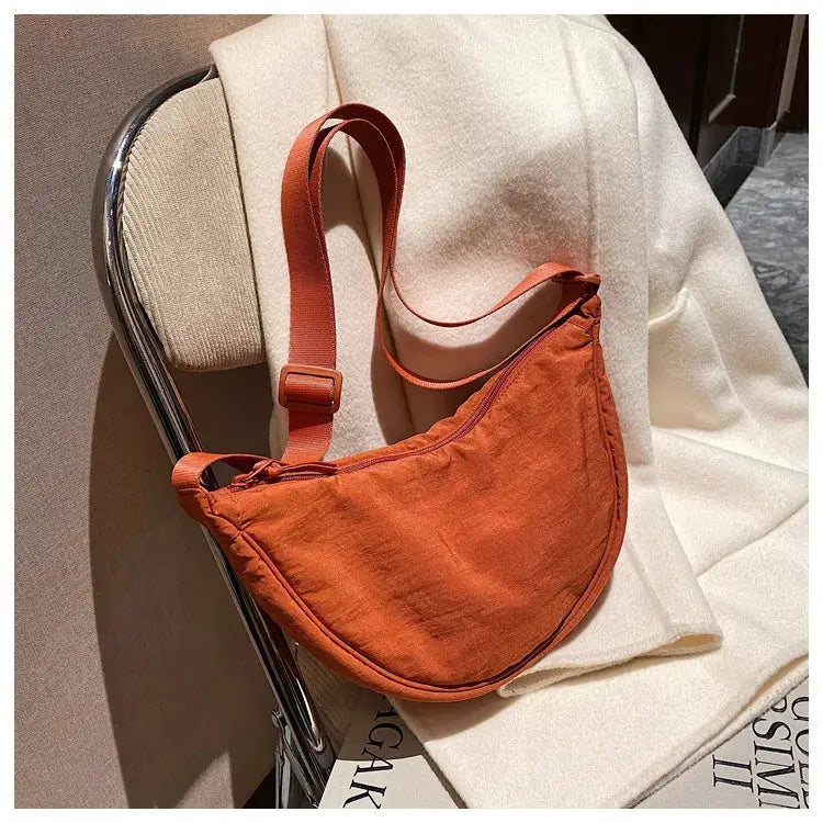 Casual nylon hobo crossbody bag in burnt orange with adjustable strap