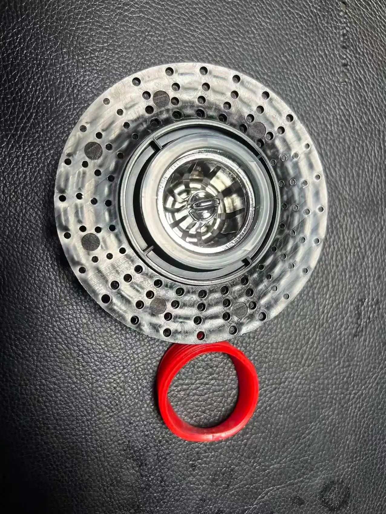 Floor drain core shower strainer with perforated metal disc and red gasket ring