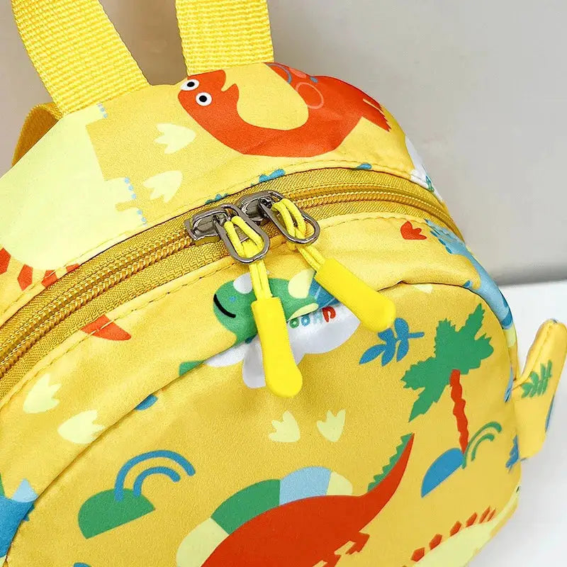 Yellow dinosaur kids backpack with cartoon print, dual zippers and yellow pulls, preschool travel bag