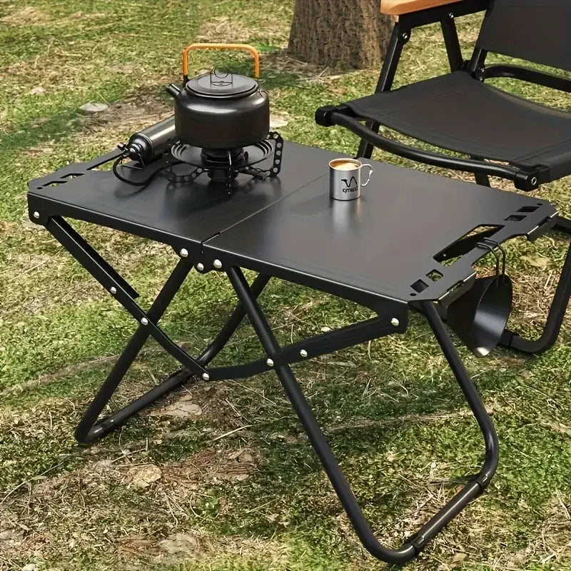 Portable folding camping table by Simples Market, black stainless steel surface with folding X-frame legs