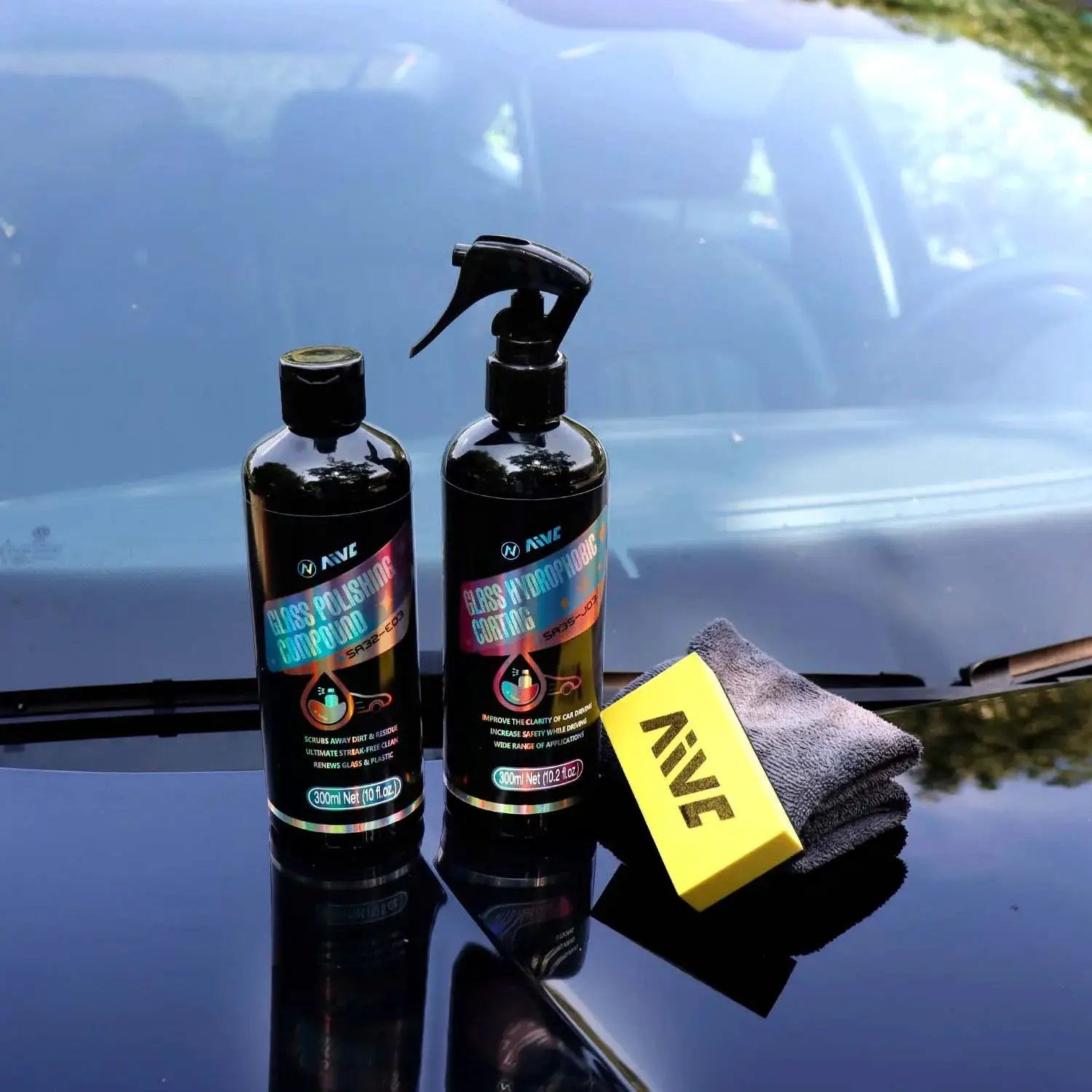 Glass polishing and hydrophobic coating kit by Simples Market; two black bottles with colorful labels and a spray top