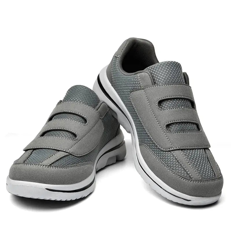 Gray wide-toe orthopedic sneakers with two Velcro straps for swollen feet