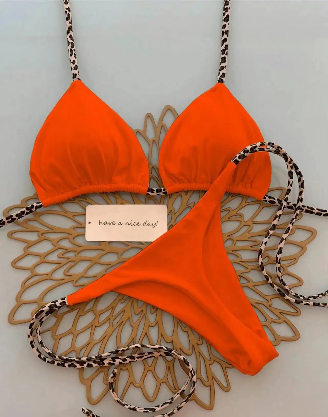 Simples Market orange leopard bikini set; triangle top with leopard straps and leopard-trim thong bottom