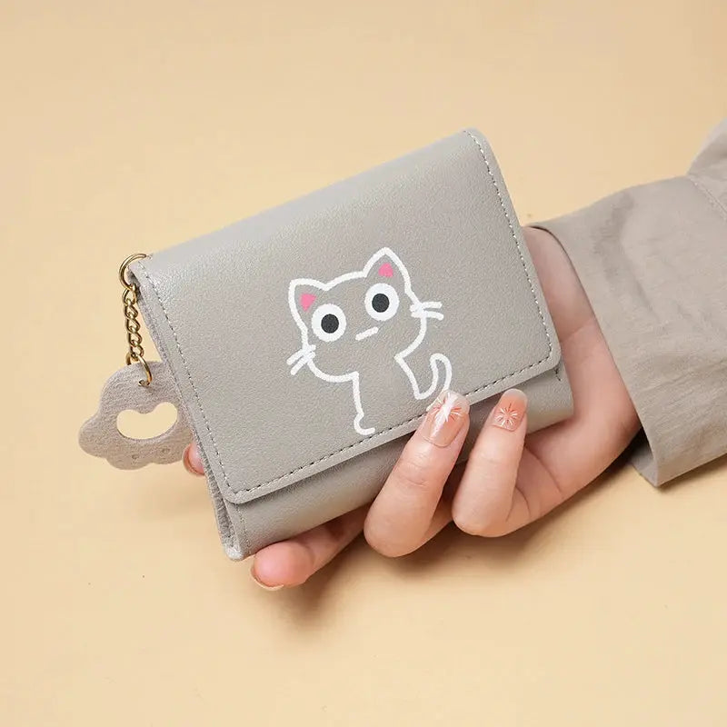 Gray short-style purse with a white cat illustration and gold chain, compact multi-card wallet.