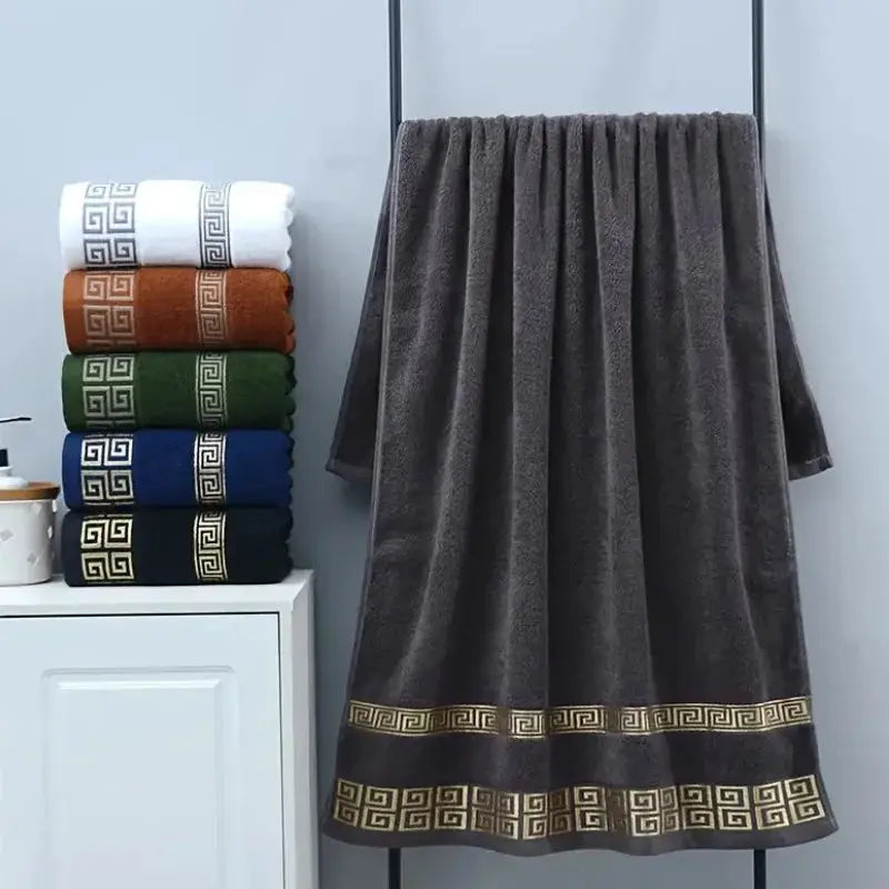 2-piece black cotton bathroom towel set with a gold Greek-key embroidered border