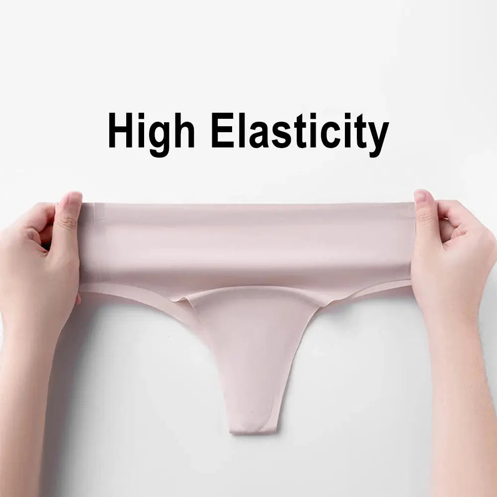 Pink seamless thong underwear with high elasticity, stretched by hands to show fit