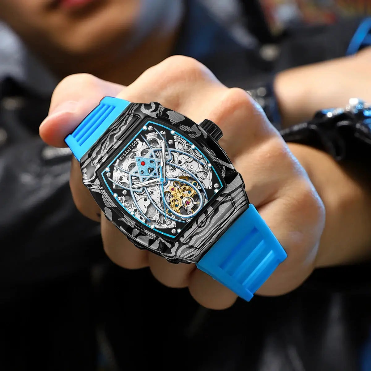 MUSANFIGO automatic hollow skeleton watch with blue silicone strap, barrel-shaped case, and luminous dial