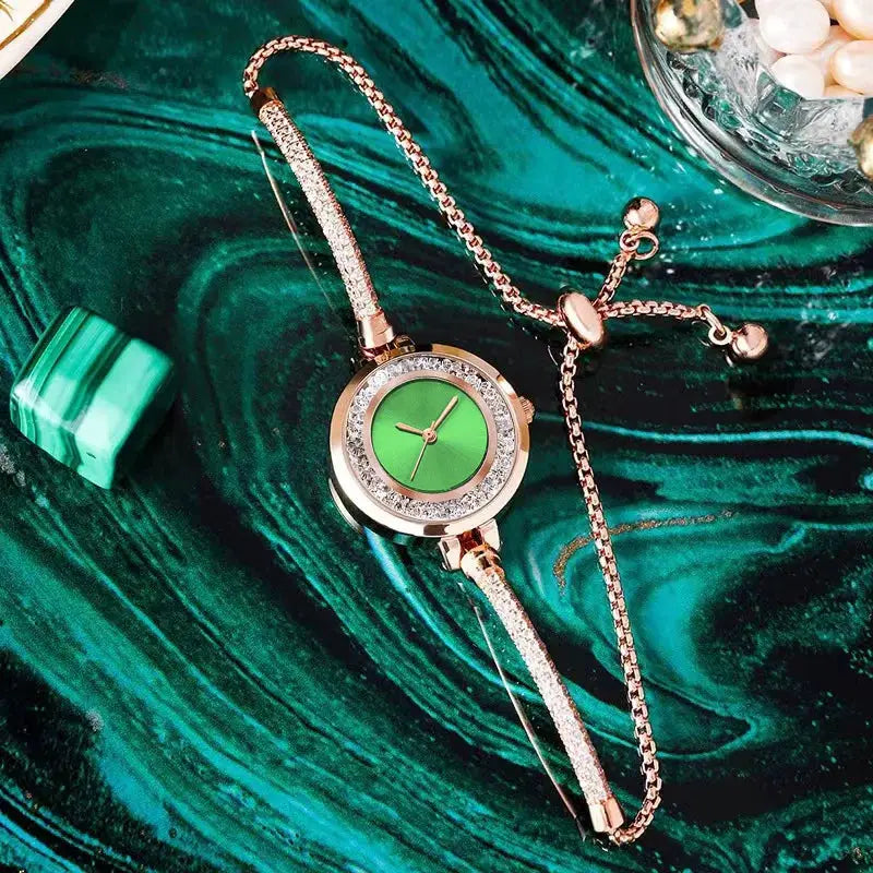 Gold-tone women's wristwatch with green dial, crystal bezel, and slim bracelet.