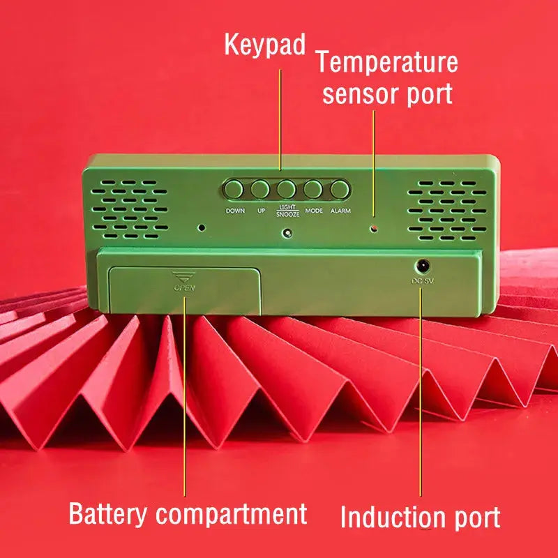Green acrylic/mirror digital alarm clock, back view with battery compartment and induction port
