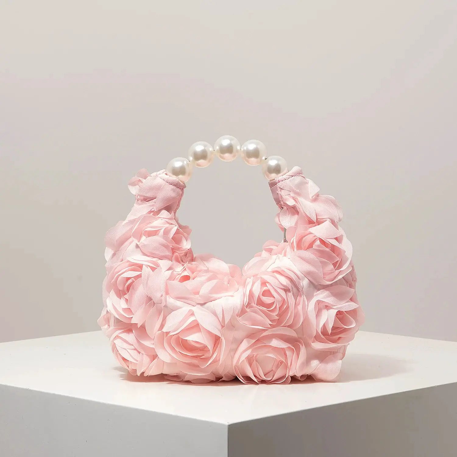 Pink floral handbag with pearl bead handle, fabric petal design