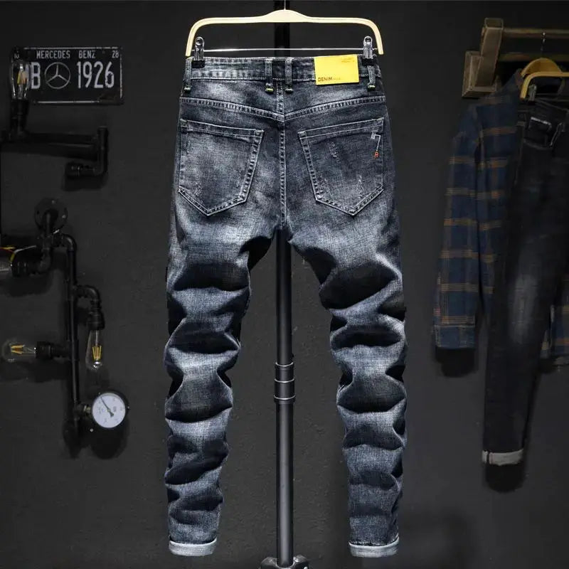 Men's jeans by Simples Market, elastic straight fit denim, blue-black with ripped worn-in look.