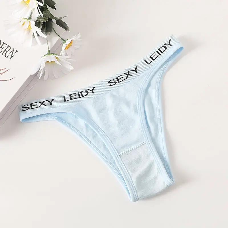 Light blue thong underwear with high-leg cut and branded waistband reading SEXY LEIDY, breathable cotton gusset.