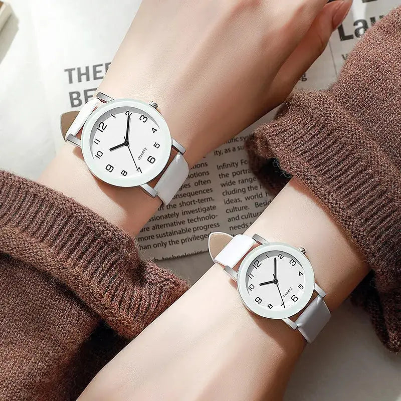 Pair of Simples Market couple's watches with white leather straps, silver cases, Arabic numeral dials