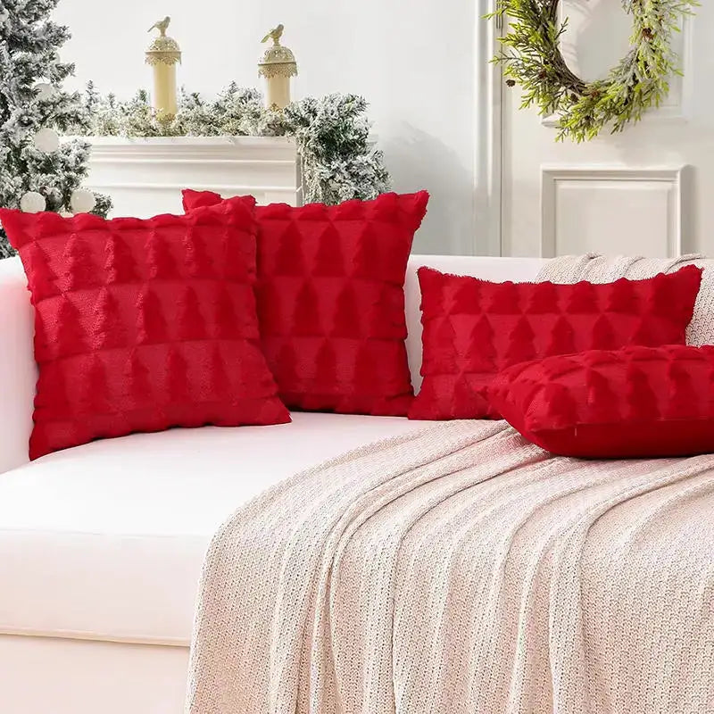Decorative pillow covers, 4 red quilted cushions on a white sofa.
