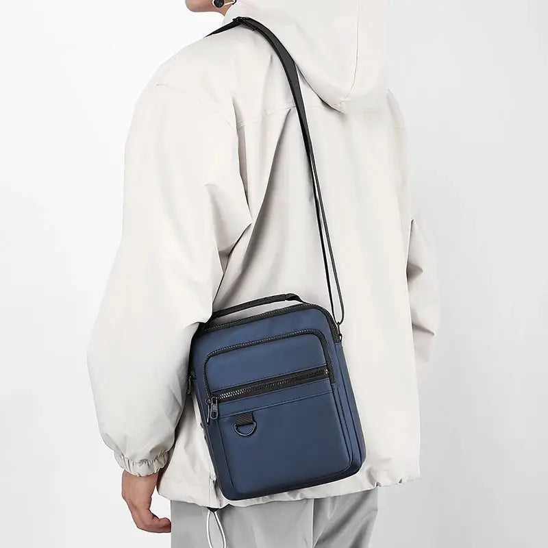Messenger sling bag, navy blue Oxford fabric with multiple zip pockets, crossbody style.