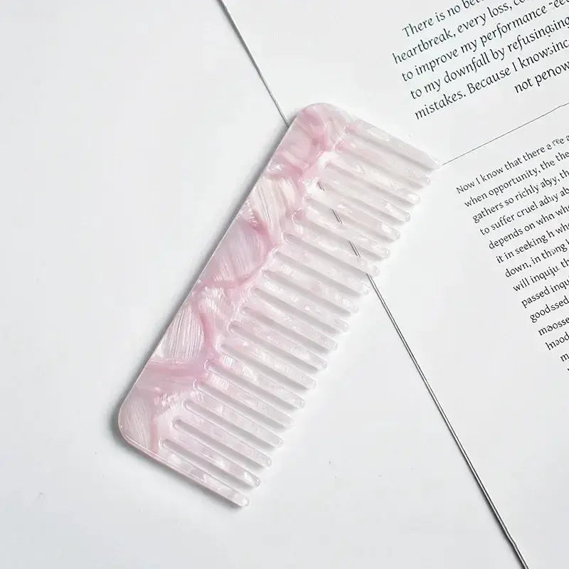 Acetate wide-tooth hair comb in pink marbled color, anti-static for salon and travel.