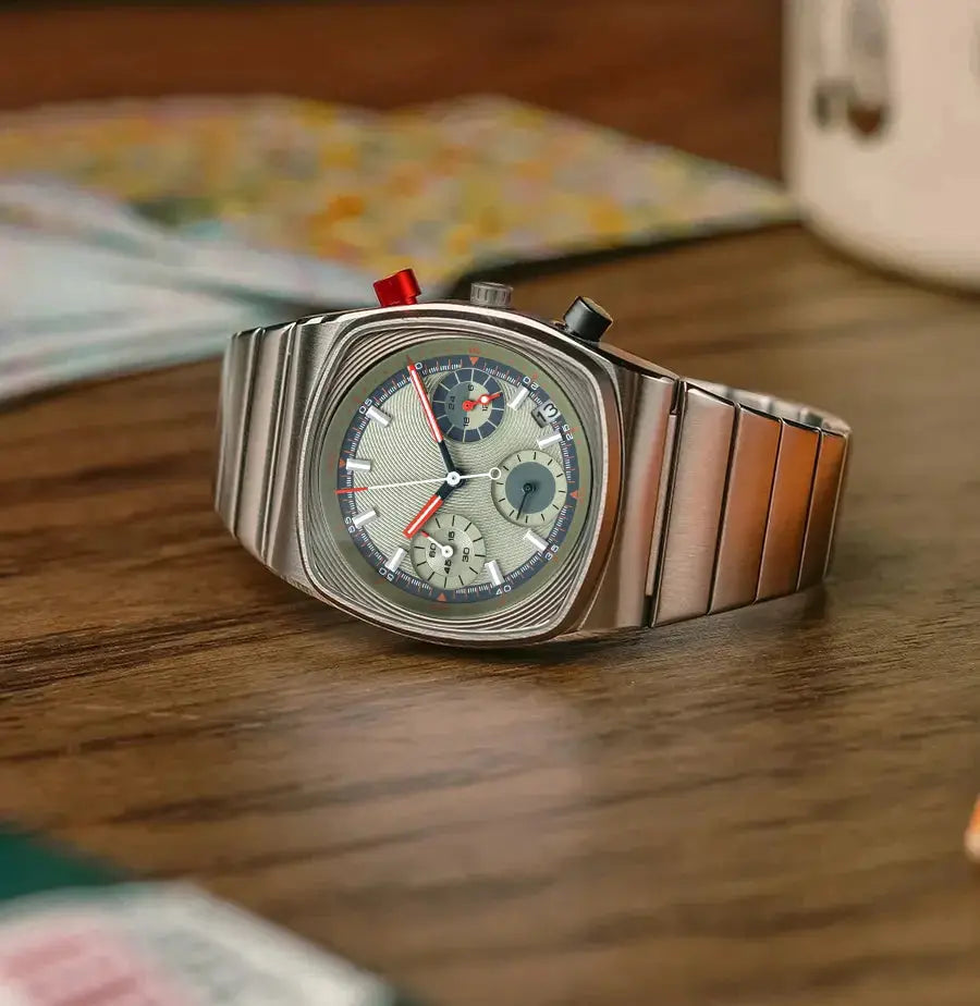 Men's square chronograph watch with stainless steel bracelet, grey dial and red accents.