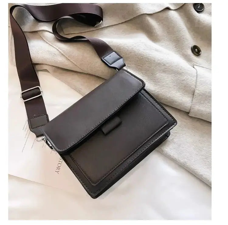 Classic designer PU leather crossbody bag for women in black with brown adjustable strap by Simples Market