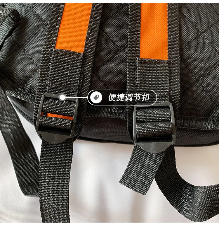 Backpack by Simples Market, black quilted schoolbag with orange straps and adjustable buckles