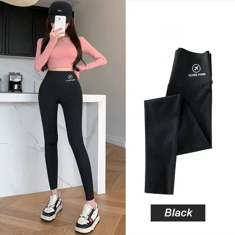 Black high-waisted yoga tights with Flying Form logo on waistband; two-view display.