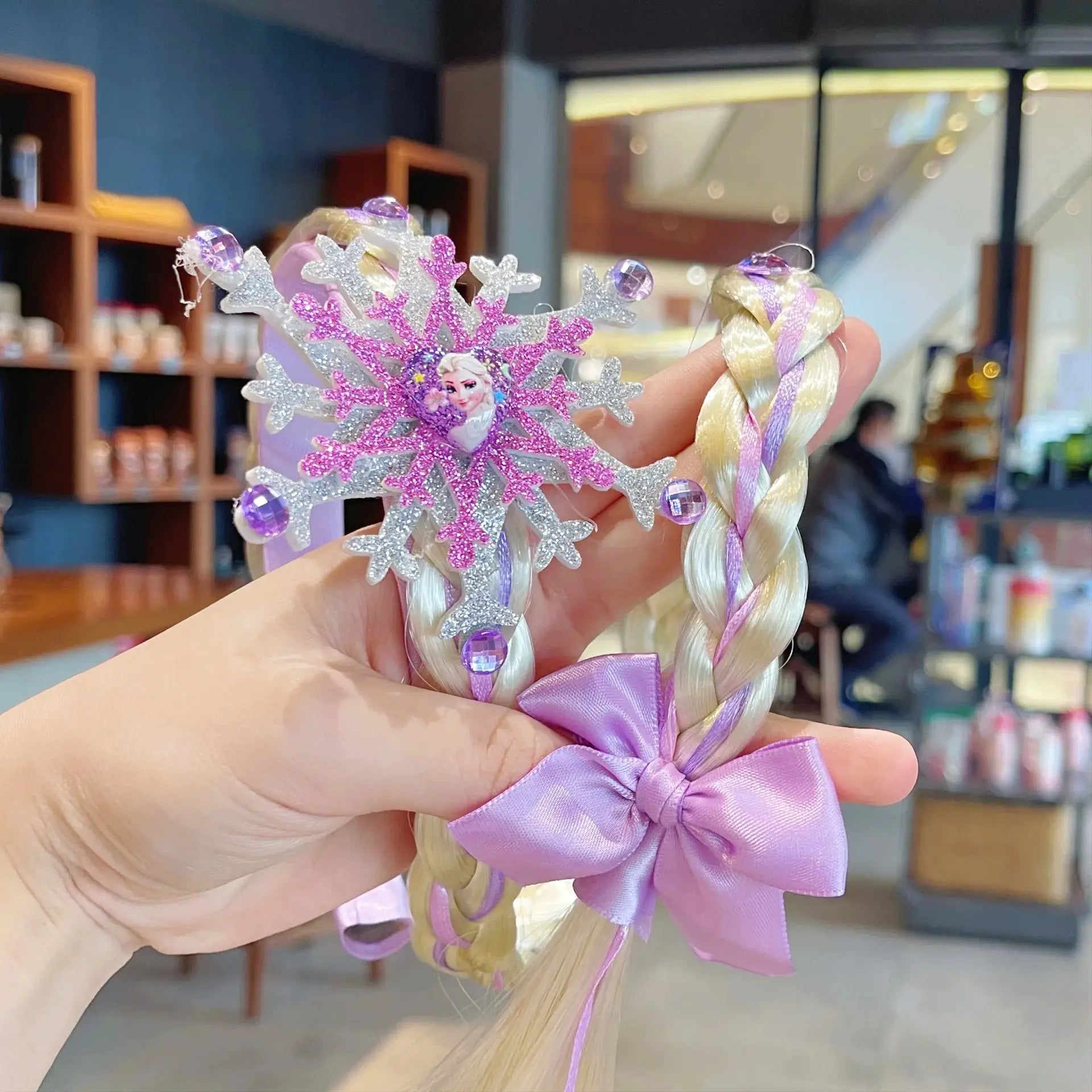 Frozen Elsa princess crown headband with glitter silver snowflakes, purple gems, braided pastel hair and lavender bow.