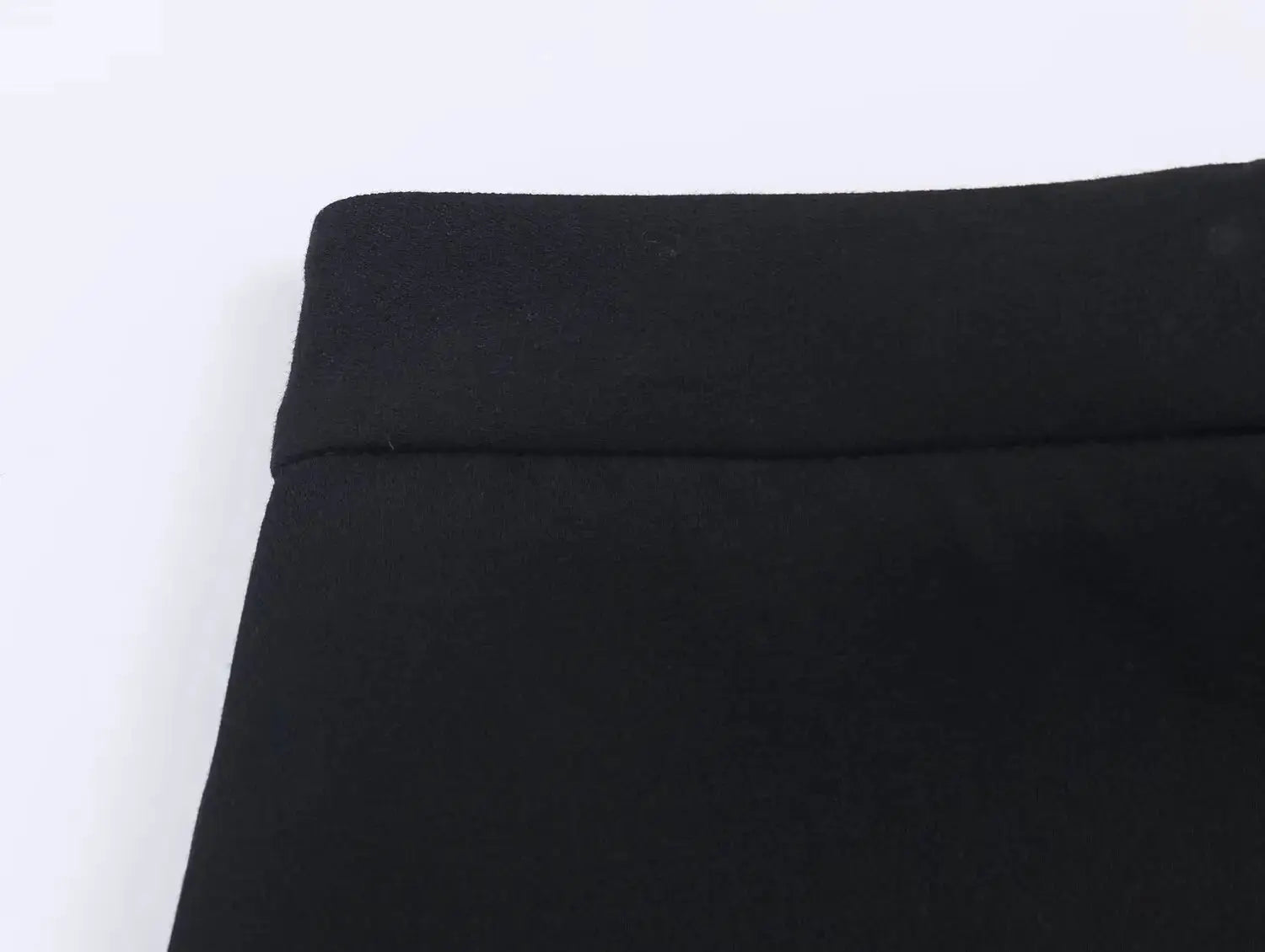Women's suit pants waistband close-up in black fabric with neat stitching