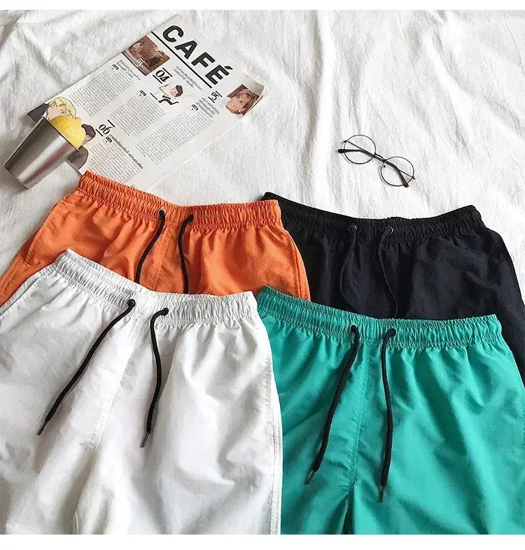 Men's swim shorts set: four colorways (orange, white, teal, black) with drawstring waists.